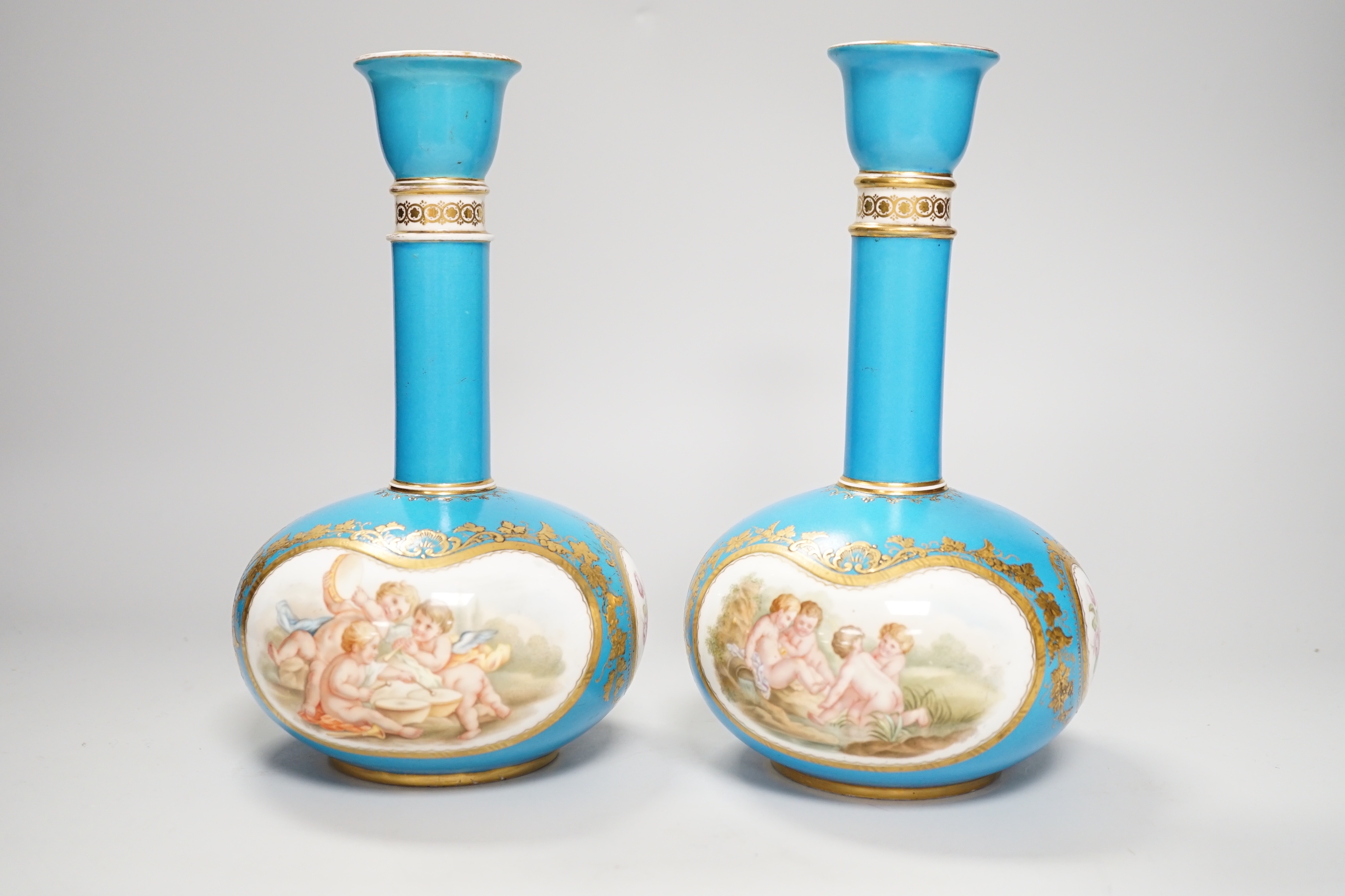 A pair of Coalport turquoise bottle vases, late 19th century, with putti and rose cartouche decoration, gilt CSN mark, 22cm high